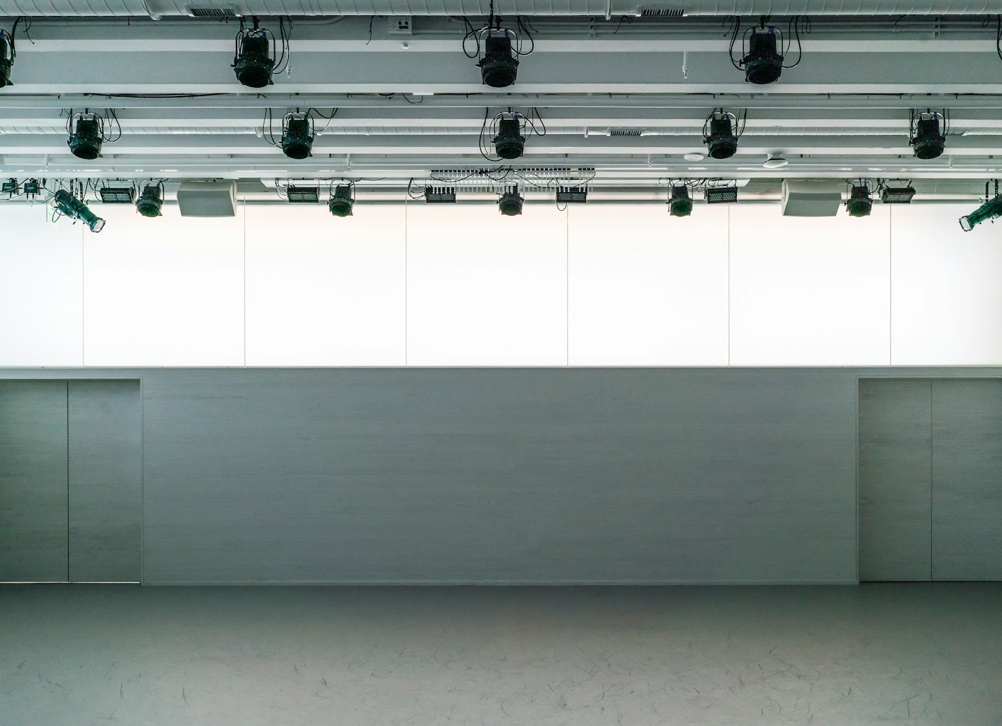Modern event venue with spotlights and grey walls.