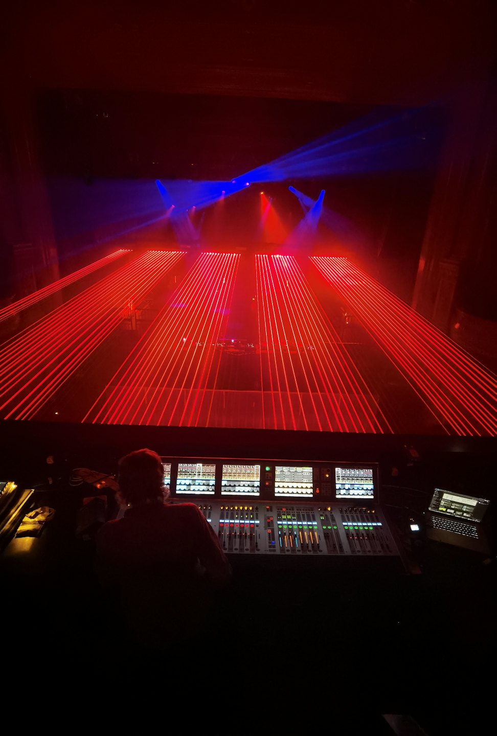 Technician controls lighting and sound at a concert.